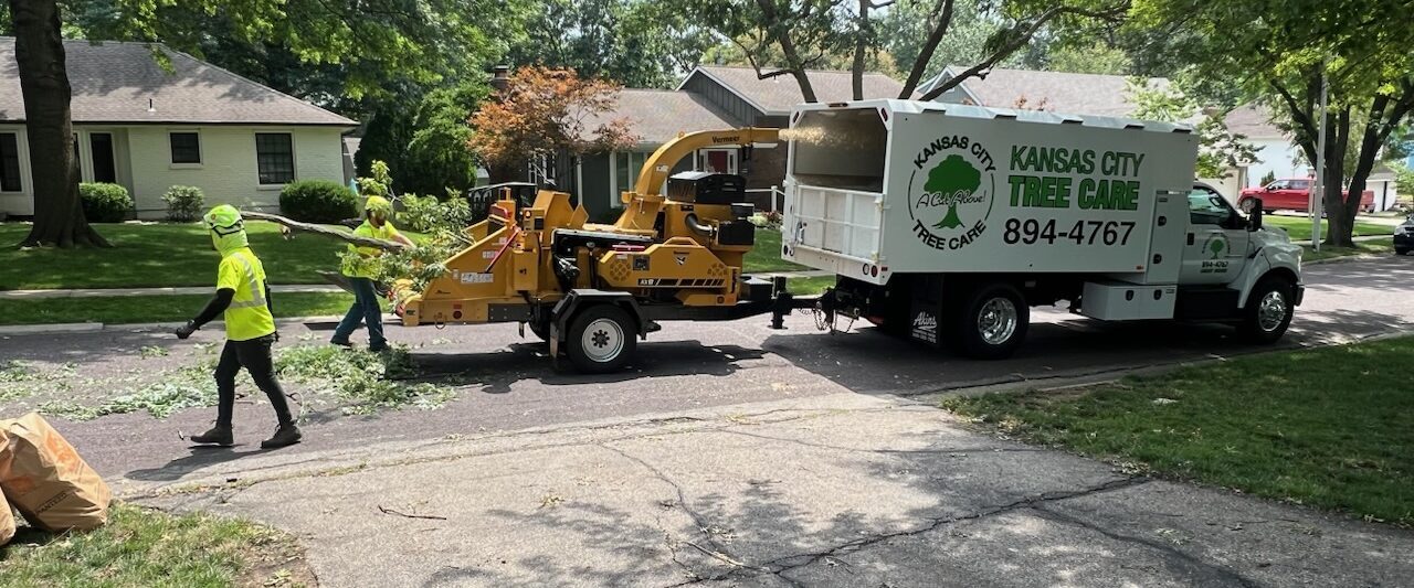 Kansas City Tree Care crew and bucket truck on a residential street