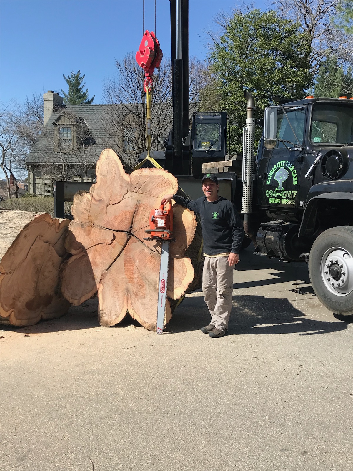 Kansas City Tree Care crew member with the crane truck